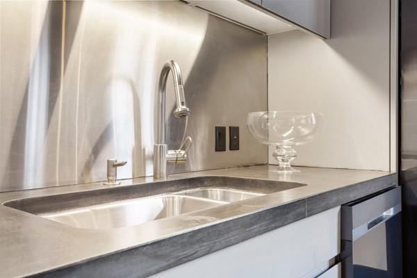 interior details featuring a sink and dishwasher