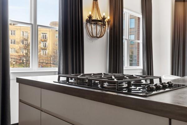 interior details with an inviting chandelier and stainless steel gas cooktop