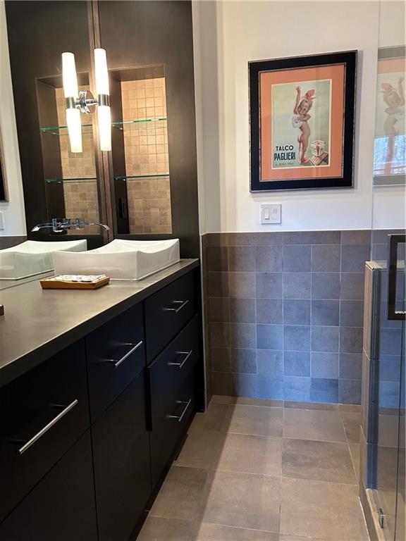 bathroom featuring tile walls, tile patterned flooring, and vanity