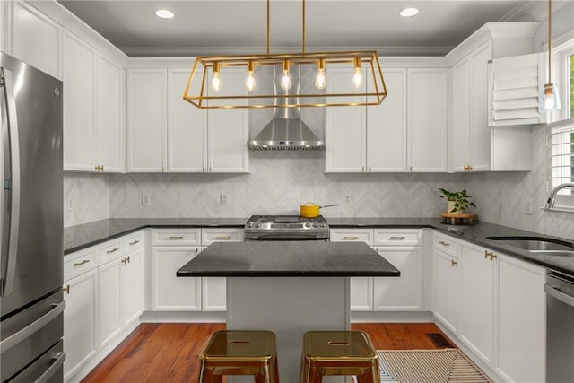 1560 Gilstrap Ln NW, Atlanta, GA 30318 - kitchen featuring stainless steel appliances, wall chimney range hood, white cabinetry, wood finished floors, and recessed lighting