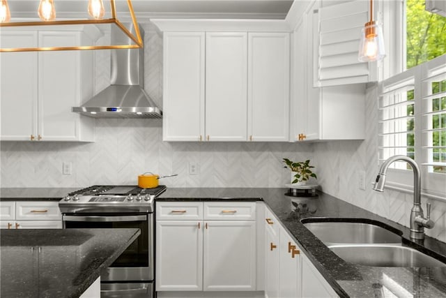 1560 Gilstrap Ln NW, Atlanta, GA 30318 - kitchen with gas range, wall chimney range hood, white cabinetry, and decorative light fixtures