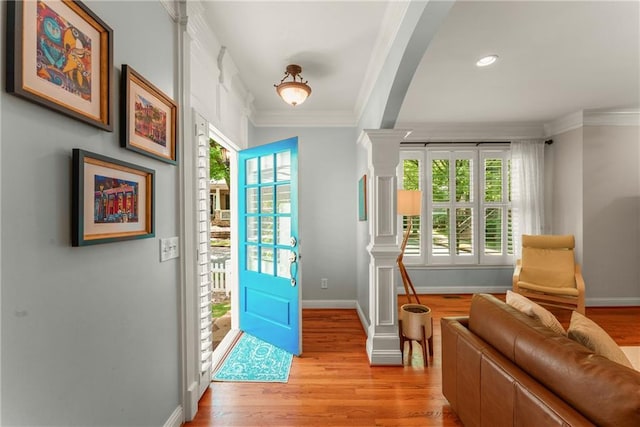 1560 Gilstrap Ln NW, Atlanta, GA 30318 - foyer with crown molding, light wood-style floors, decorative columns, and recessed lighting