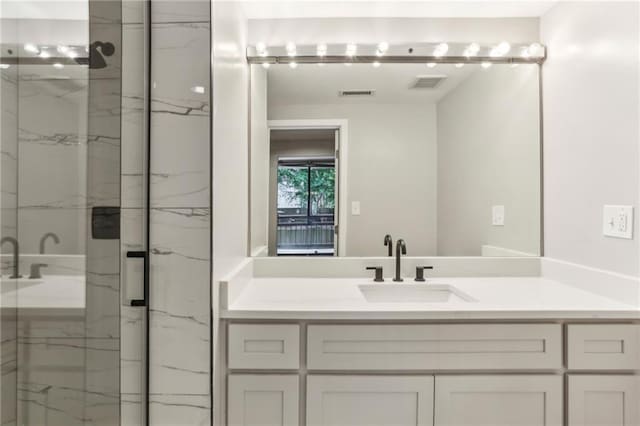 1130 Piedmont Ave NE Unit 410, Atlanta, GA 30309 - bathroom with visible vents, a marble finish shower, and vanity