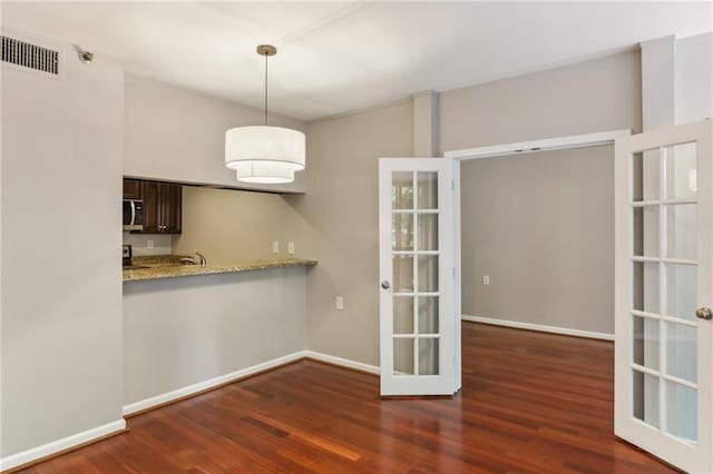 1130 Piedmont Ave NE Unit 410, Atlanta, GA 30309 - unfurnished dining area with visible vents, baseboards, wood finished floors, and french doors