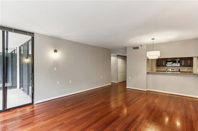 1130 Piedmont Ave NE Unit 410, Atlanta, GA 30309 - unfurnished living room with baseboards, wood finished floors, and visible vents