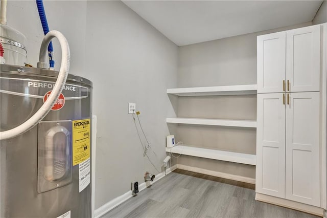 utility room featuring water heater