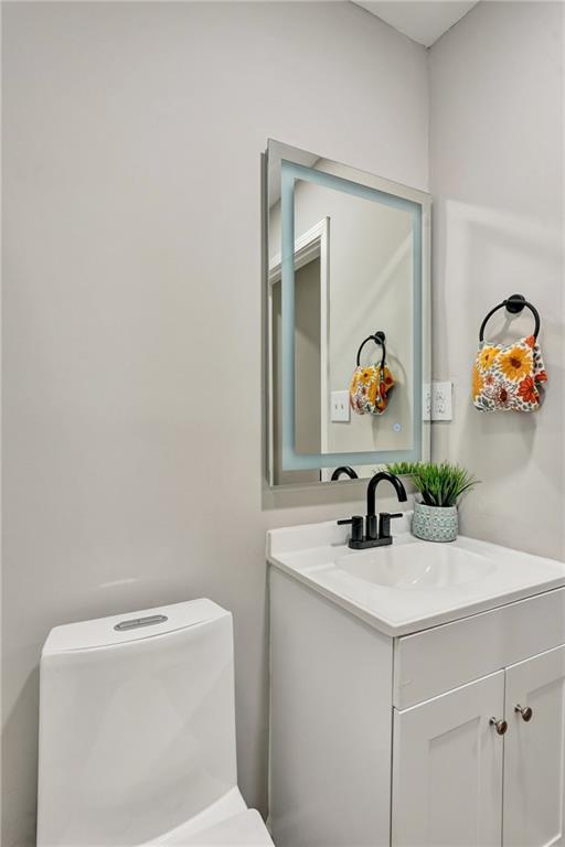 bathroom featuring vanity and toilet