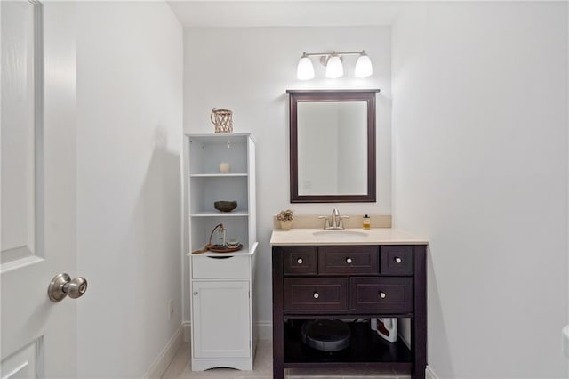 bathroom with vanity and baseboards