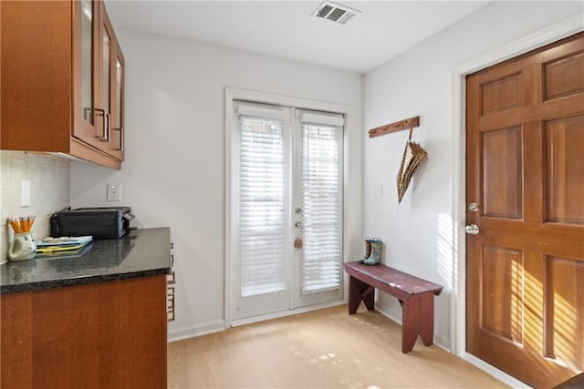 doorway to outside with french doors, visible vents, and baseboards