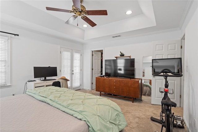 bedroom featuring light colored carpet, a raised ceiling, visible vents, and recessed lighting