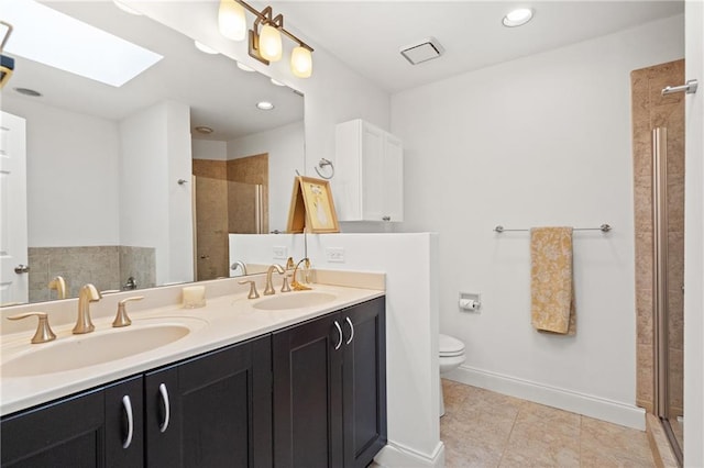 full bath featuring toilet, a skylight, baseboards, and a sink