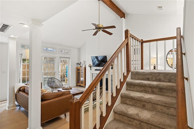 stairway with ornate columns, ceiling fan, visible vents, and beamed ceiling