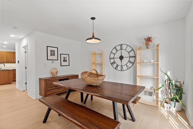 dining space with light wood-type flooring, baseboards, visible vents, and recessed lighting