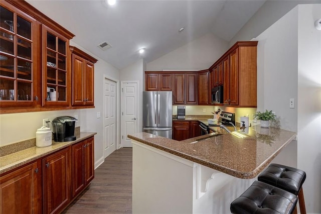 kitchen with visible vents, glass insert cabinets, dark wood-style floors, stainless steel appliances, and a sink