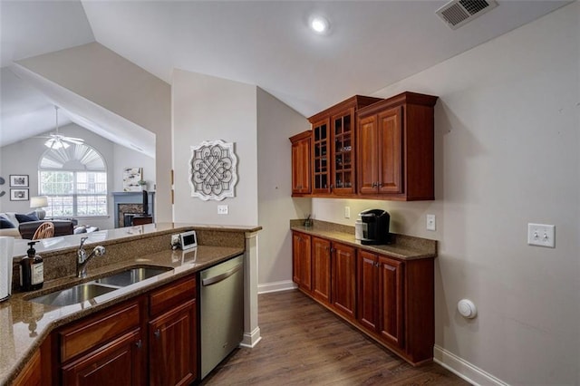 kitchen with visible vents, glass insert cabinets, dishwasher, vaulted ceiling, and a sink