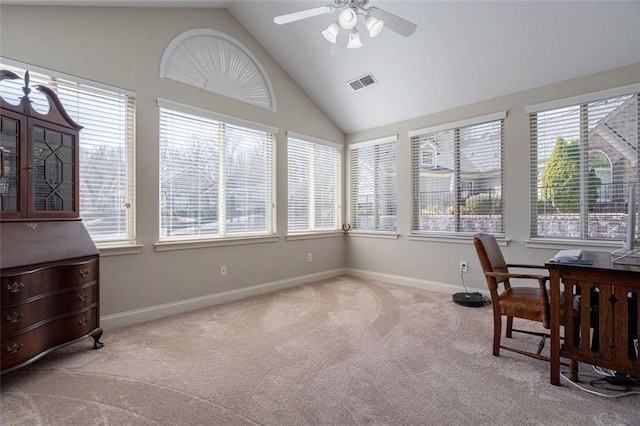 sunroom featuring visible vents, ceiling fan, and vaulted ceiling