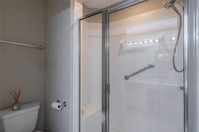 full bathroom with toilet and a shower stall