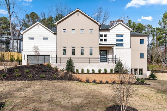 view of front of home featuring a balcony and a front lawn