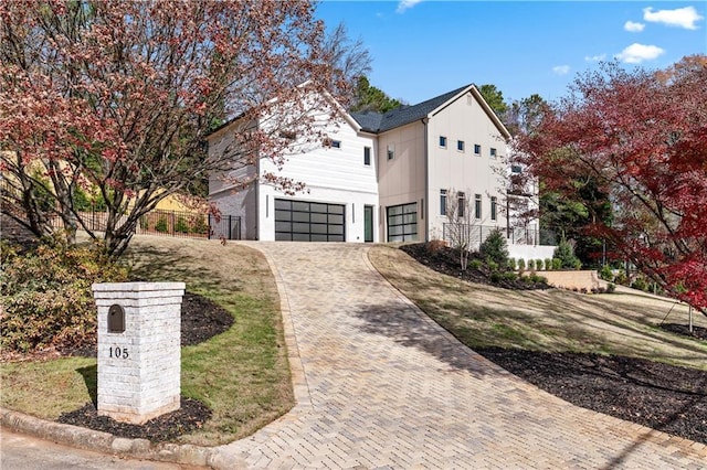 view of front of property featuring a front yard and a garage