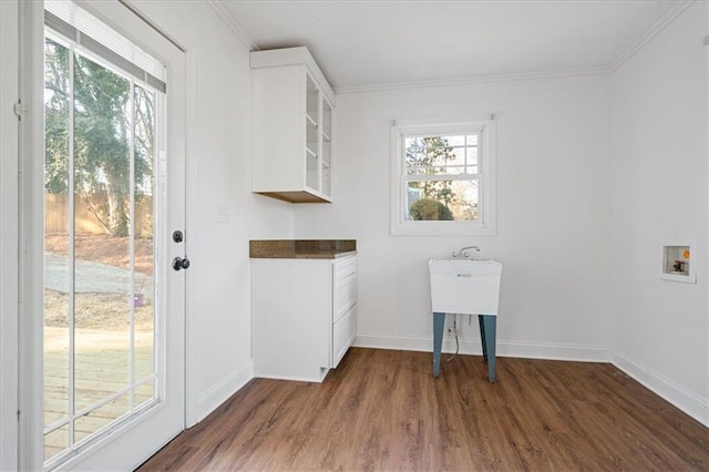 laundry area featuring baseboards, ornamental molding, washer hookup, laundry area, and dark wood-style flooring