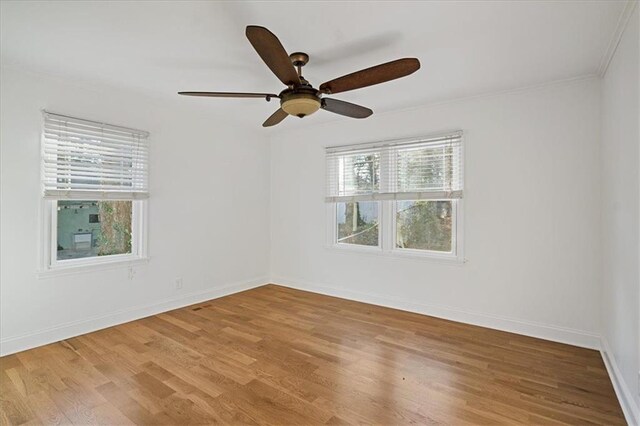 spare room featuring crown molding, ceiling fan, and light hardwood / wood-style flooring