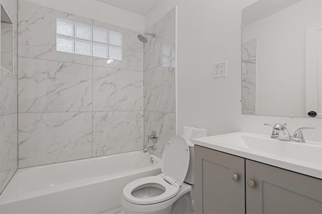 full bathroom featuring vanity, tiled shower / bath combo, and toilet