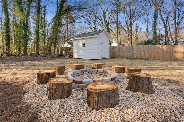 view of patio / terrace with a storage shed and an outdoor fire pit