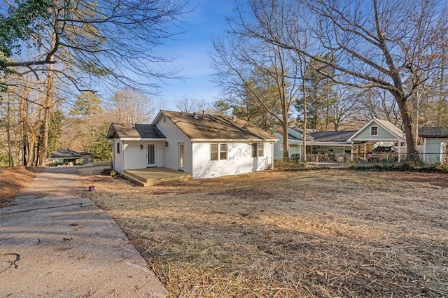 view of side of home with driveway