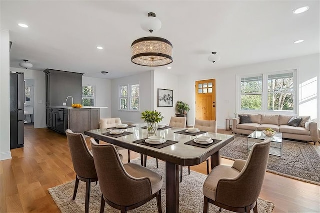 dining space with recessed lighting and light wood-type flooring