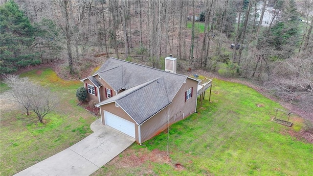 drone / aerial view featuring a view of trees