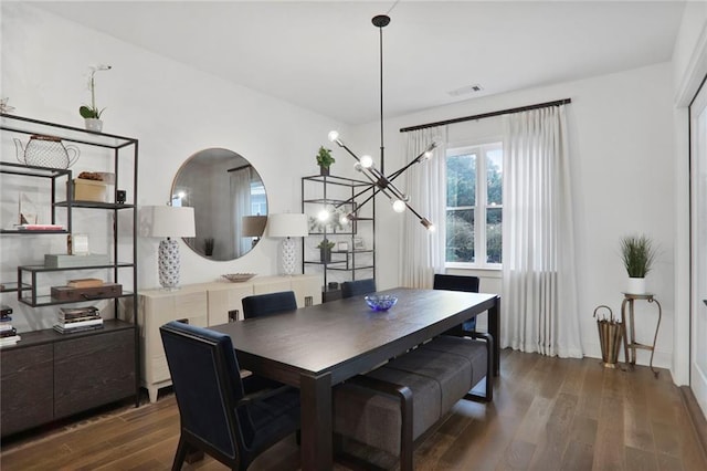 dining area featuring an inviting chandelier and dark hardwood / wood-style flooring