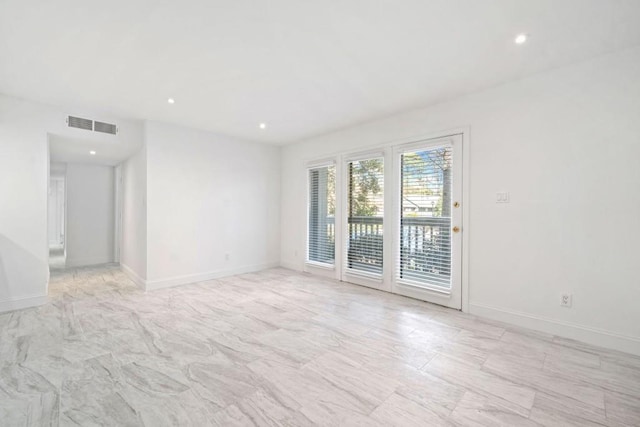 unfurnished room featuring visible vents, recessed lighting, and baseboards