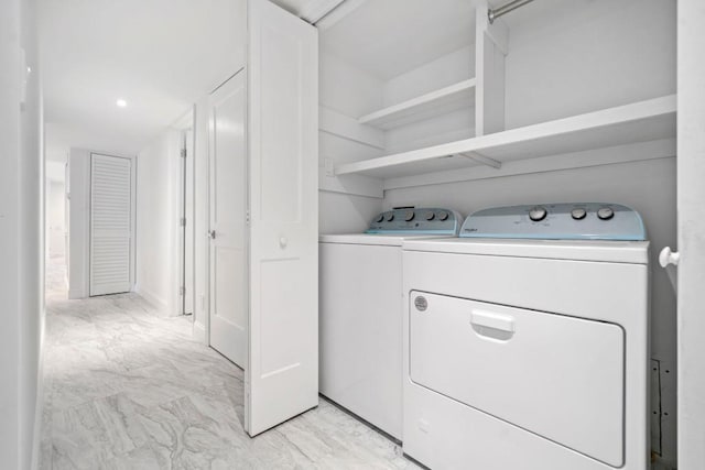 laundry area featuring marble finish floor, independent washer and dryer, and laundry area