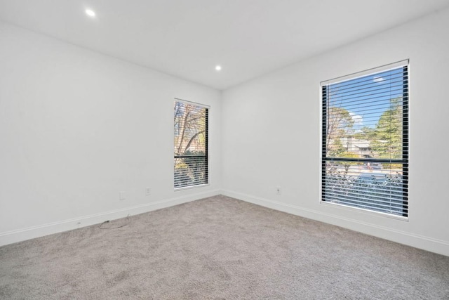 carpeted empty room with recessed lighting and baseboards