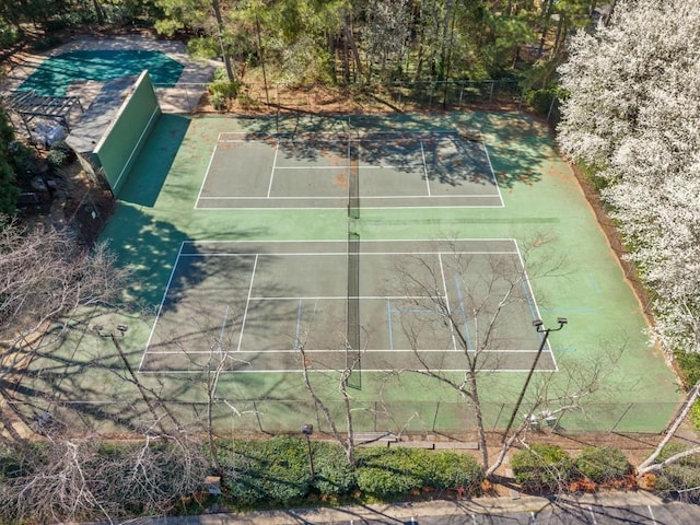 view of tennis court featuring fence