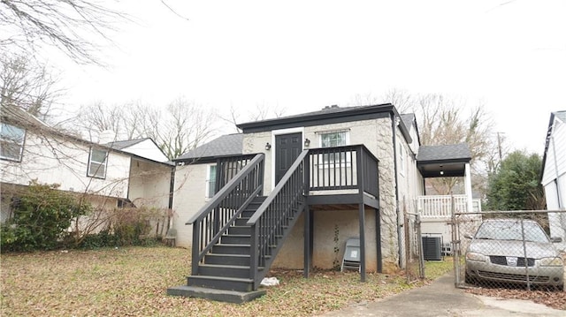 rear view of property featuring central AC