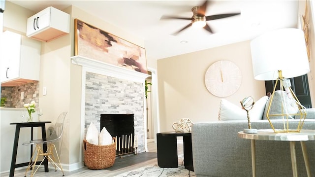 interior space with ceiling fan, a fireplace, and hardwood / wood-style floors