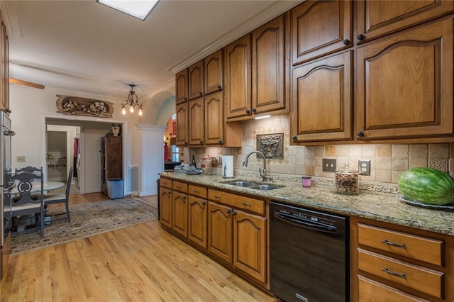 kitchen with an inviting chandelier, light wood-type flooring, tasteful backsplash, dishwasher, and sink