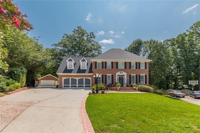 colonial home with a front lawn and a garage