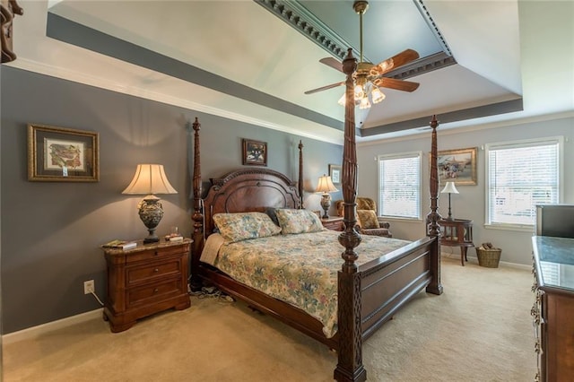 bedroom with light colored carpet, a raised ceiling, ornamental molding, and ceiling fan