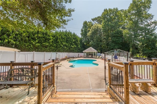 view of pool featuring a deck, a gazebo, and a patio