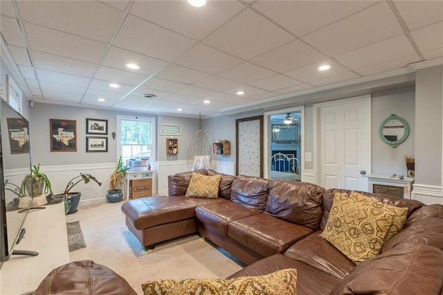 living room with light carpet and a drop ceiling