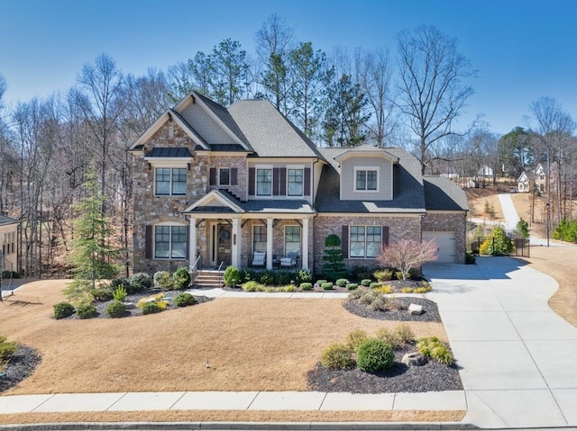 craftsman-style home featuring stone siding and driveway