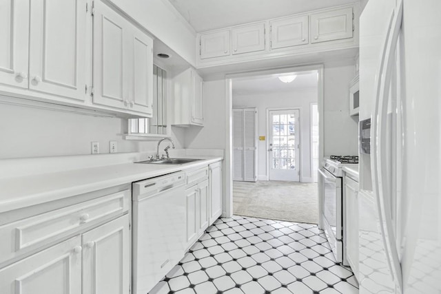 kitchen featuring sink, white cabinets, light colored carpet, and white appliances