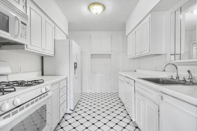 kitchen with white cabinets, white appliances, and sink