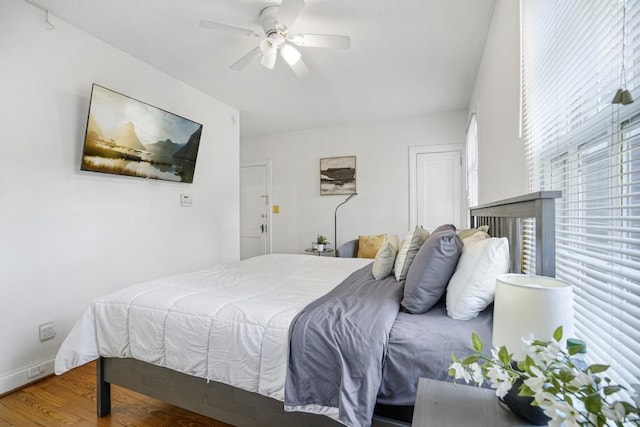 bedroom with ceiling fan and wood-type flooring