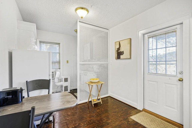 office area featuring a textured ceiling, dark hardwood / wood-style floors, and plenty of natural light