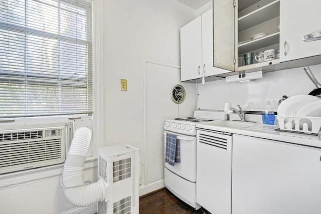 kitchen featuring white cabinets, dark wood-type flooring, and white range