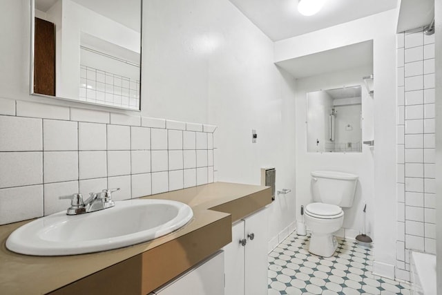 bathroom with tasteful backsplash, vanity, tile walls, and toilet