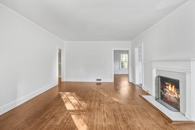 unfurnished living room with crown molding and wood-type flooring